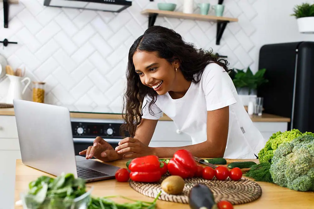 image of young woman using laptop to access health coaching